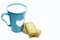 Closeup of a blue mug with a heart next to dry bread slices isolated on white background Royalty Free Stock Photo