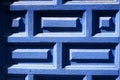 Closeup of blue painted wooden entrance door. Part of renovated door with pattern