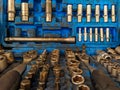 Closeup of blue plastic toolbox with all the necessary tools and screws aligned and organized for professionals at the mechanic