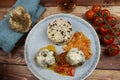 Closeup of blue plate on wood table with homemade minced meat balls gratinated with mozzarella cheese in fresh tomato sauce with Royalty Free Stock Photo