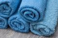Blue rolled bath towels on wooden table in bathroom Royalty Free Stock Photo
