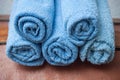 blue rolled bath towels on wooden trunk in bathroom Royalty Free Stock Photo