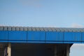 Closeup of the blue roof of metal sheets under the blue sky Royalty Free Stock Photo