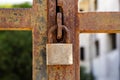 Closeup a blue rusty old metal door locked with a metal padlock. Grunge style and good texture. Security concept. Royalty Free Stock Photo