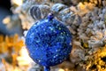 Closeup of a Blue Sequined Christmas Ball Ornament Hung on a Christmas Tree