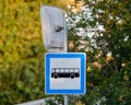 Closeup of a blue signpost of a bus station