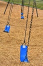 Closeup of blue swings on playground