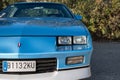 Closeup of a blue third-generation Chevrolet Camaro 5.0 classic muscle car parked on the street