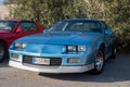 Closeup of a blue third-generation Chevrolet Camaro 5.0 classic muscle car parked on the street