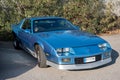 Closeup of a blue third-generation Chevrolet Camaro 5.0 classic muscle car parked on the street