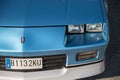 Closeup of a blue third-generation Chevrolet Camaro 5.0 classic muscle car parked on the street