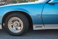 Closeup of a blue third-generation Chevrolet Camaro 5.0 classic muscle car parked on the street