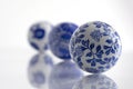 Closeup of a blue & white porcelain decor balls against a white background