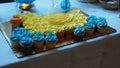 Closeup of blue and yellow cupcakes for duck-themed baby shower