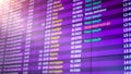 Closeup blurred image of departure times of flights on big display in airport