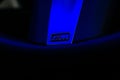 Closeup of BMW M sport steering wheel badge under blue light