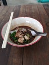 Boat noodles small noodles pork ball in bowl on wooden table