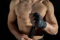 Closeup of a body combat athlete aplying tape on the hands. Royalty Free Stock Photo