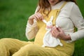 Expecting young female mother posing in park holding plush toy