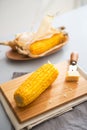 Closeup on boiled corn and butter on cutting board Royalty Free Stock Photo