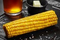 Closeup of boiled corn on cob on slate board with butter and salt Royalty Free Stock Photo