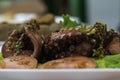 Closeup of boiled octopus with salad and tomatoes and mojo sauce. On a white plate. Tasty cousine in Garachico.