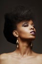 Bold African American woman with a fierce hairstyle and makeup