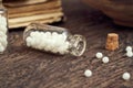 A bottle of homeopathic pills on a wooden table