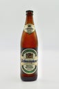 A closeup of a bottle of Weihenstephaner Kristall Weissbier against a white background