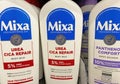 Closeup of bottles Mixa urea and panthenol skin care repair lotion in shelf of german supermarket