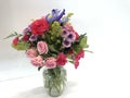 Closeup of a bouquet of beautiful flowers in a glass vase isolated on white background Royalty Free Stock Photo