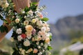 Closeup of a bouquet of colorful roses decorating a wedding event outside on a blurred background Royalty Free Stock Photo