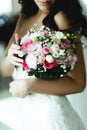 A closeup of a bouquet in tender bride`s hands