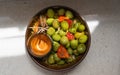 Closeup of a bowl of aceitunas, green olives and cut peppers shining from having an oily surface