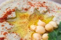 Closeup of A bowl of creamy hummus with olive oil.