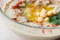 Closeup of A bowl of creamy hummus with olive oil.