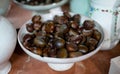 Closeup of a bowl of freshly roasted chestnuts in a kitchen