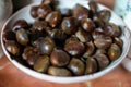 Closeup of a bowl of freshly roasted chestnuts in a kitchen