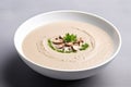 Closeup of a bowl of mushroom cream soup puree on a grey background