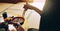 Closeup of bowl of noodles, hands and man is eating food, nutrition and sushi with chopsticks in Japan. Hungry for Royalty Free Stock Photo