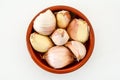 Closeup of a bowl of pink garlic cloves