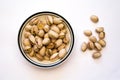 Bowl of Pistachio Nuts on a White Background