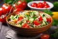 closeup of a bowl of quinoa salad with cucumbers and tomatoes