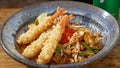 Closeup of a bowl of Shrimp Pad on a wooden table
