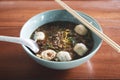Closeup of a bowl of soup noodles with meatballs