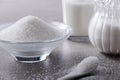 Closeup bowl and spoon with white sand on stone table background