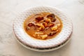 Closeup of a bowl of thick red seafood stew