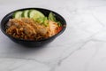 Closeup of a bowl of Vietnamese grilled pork on noodles on a white table with space for your text