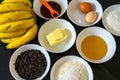 Closeup of bowls of baking ingredients for balking banana and chocolate cake