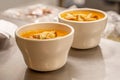 Closeup of a bowls of fresh and tasty tomato soup with bread